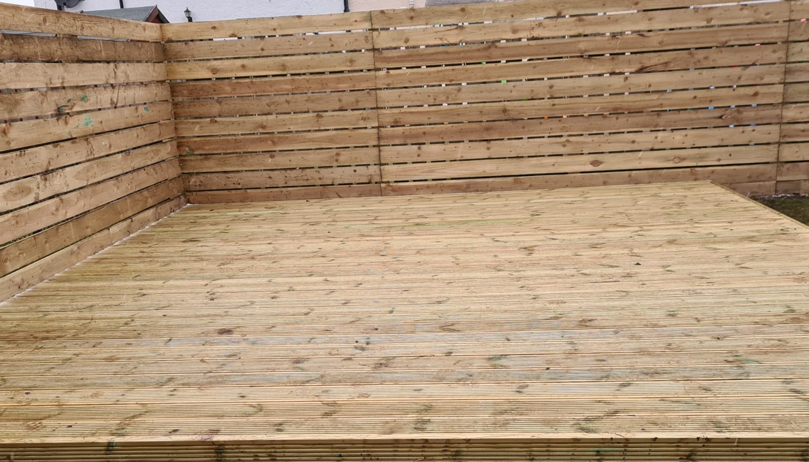 New timber deck inside a horizontal slatted fence
