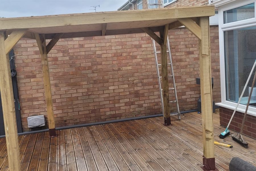 Timber pergola over an existing deck, brick wall behind