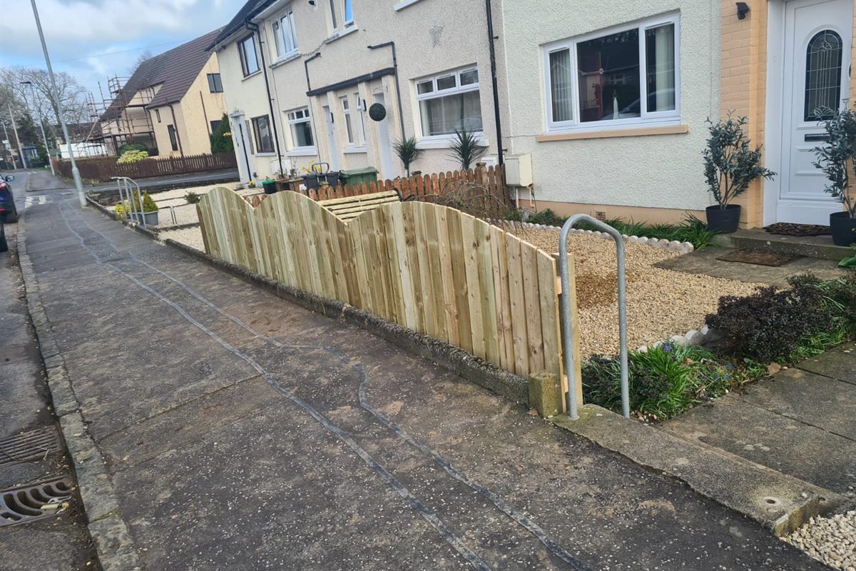 New scalloped picket fence along a front garden on a terraced street