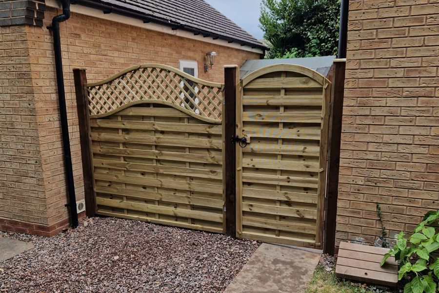 Timber gate and trellis-top panel between two houses