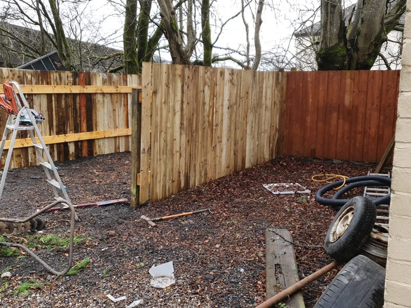 New fence posts and panels going in with an auger and ladder on site