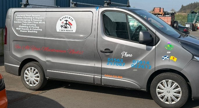 The signwritten Handyman 2 Your Rescue van, the real one, side on with the round badge and the list of services.