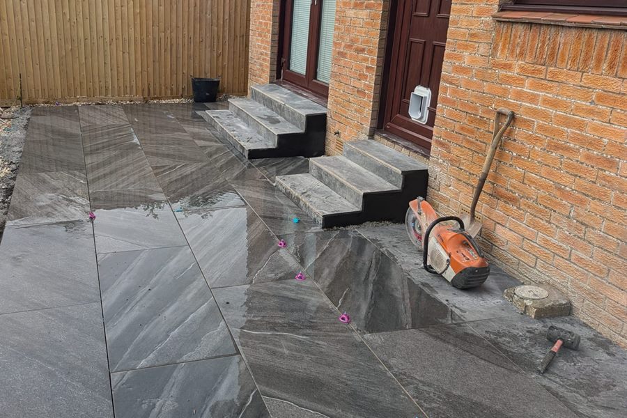 Dark porcelain patio and steps at a back door