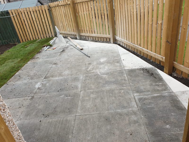 Slabs going down on a prepared base under a new fence