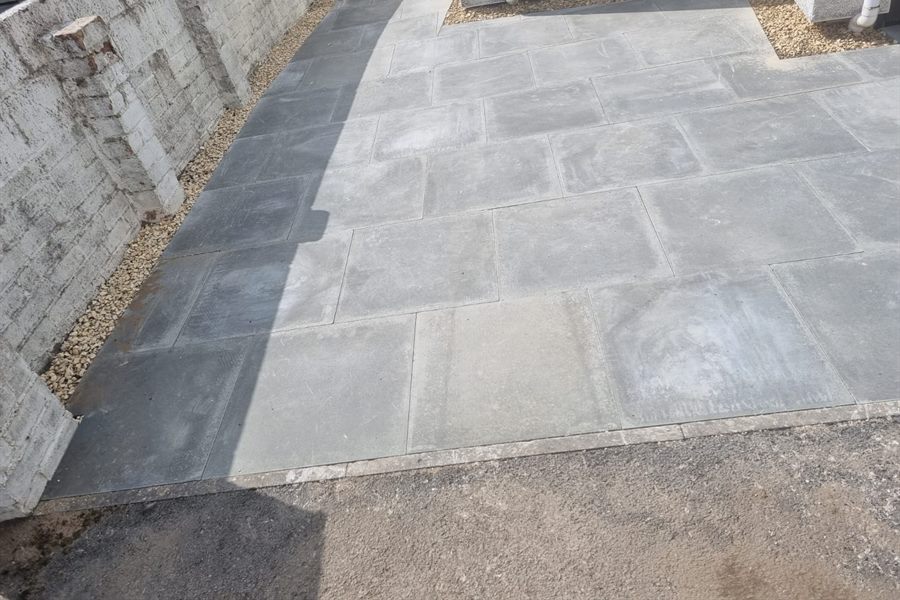 Slabbed patio inside a new block wall with a gravel border