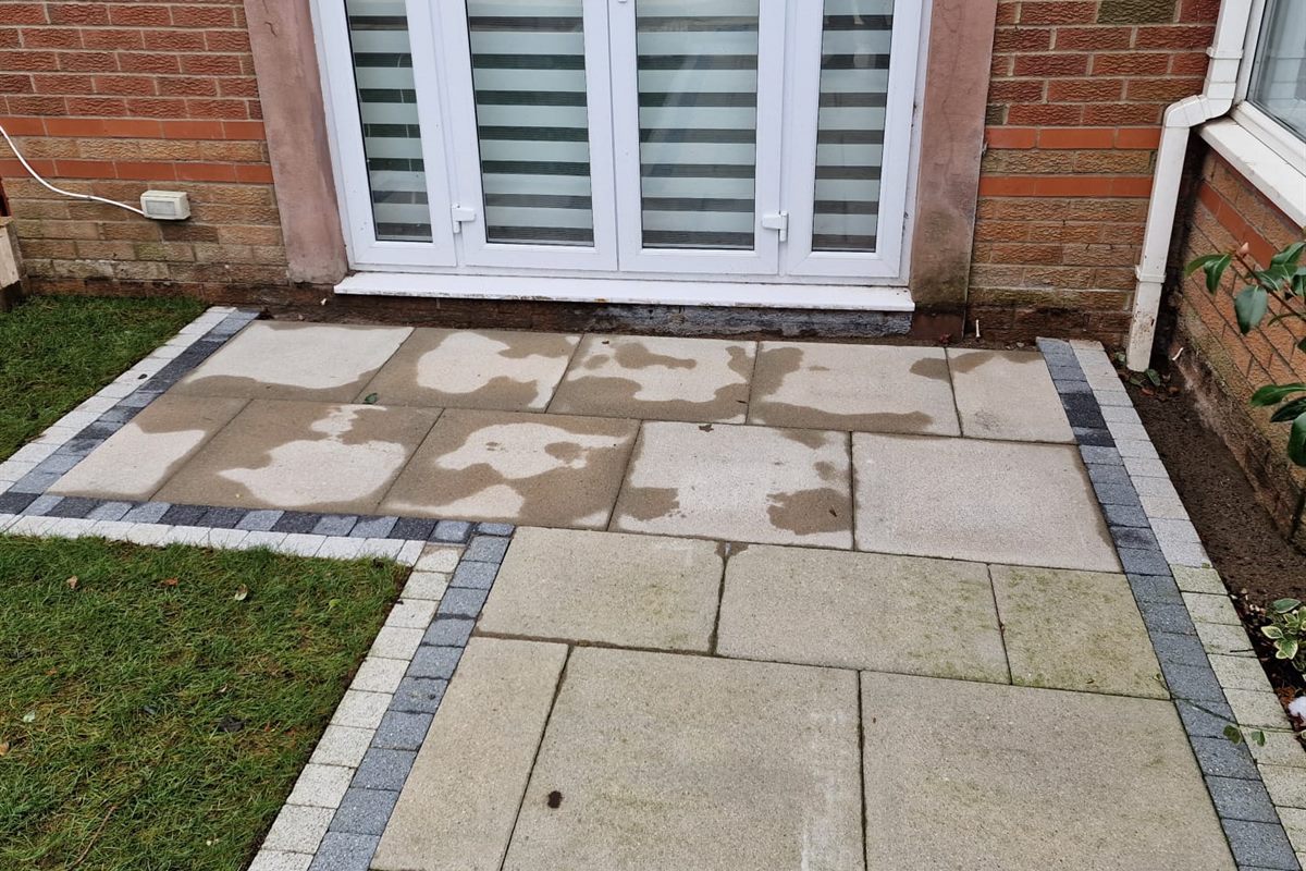 Slabbed patio at a back door with a charcoal block border