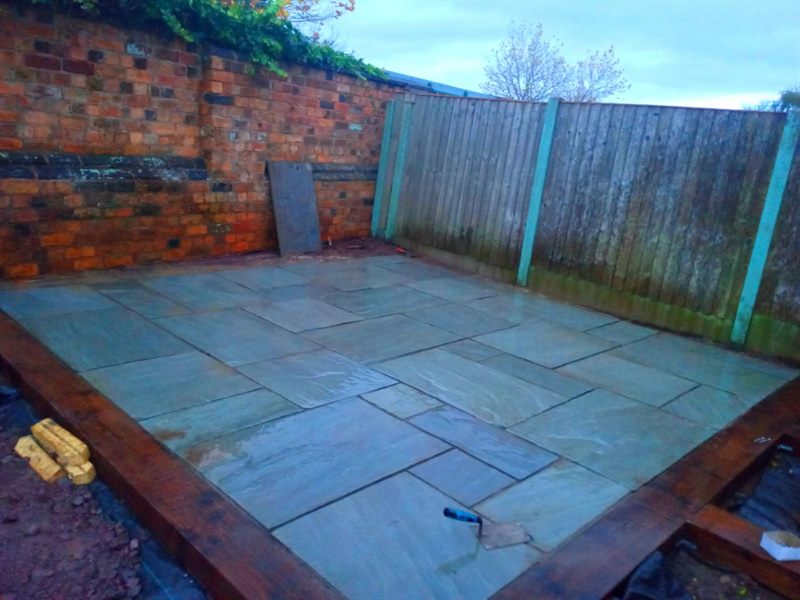 Sandstone slabs being laid inside a sleeper edge