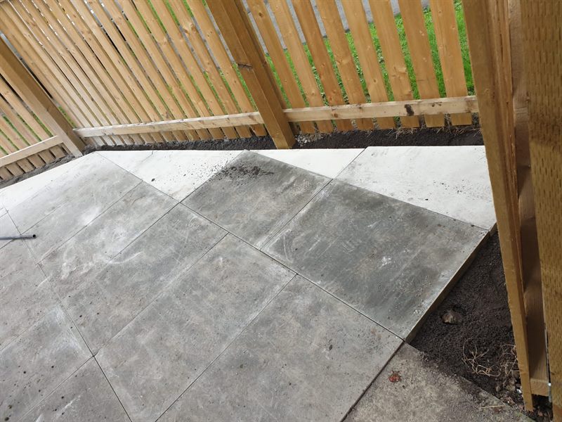 Slabs meeting a new fence line with the edge bedded in