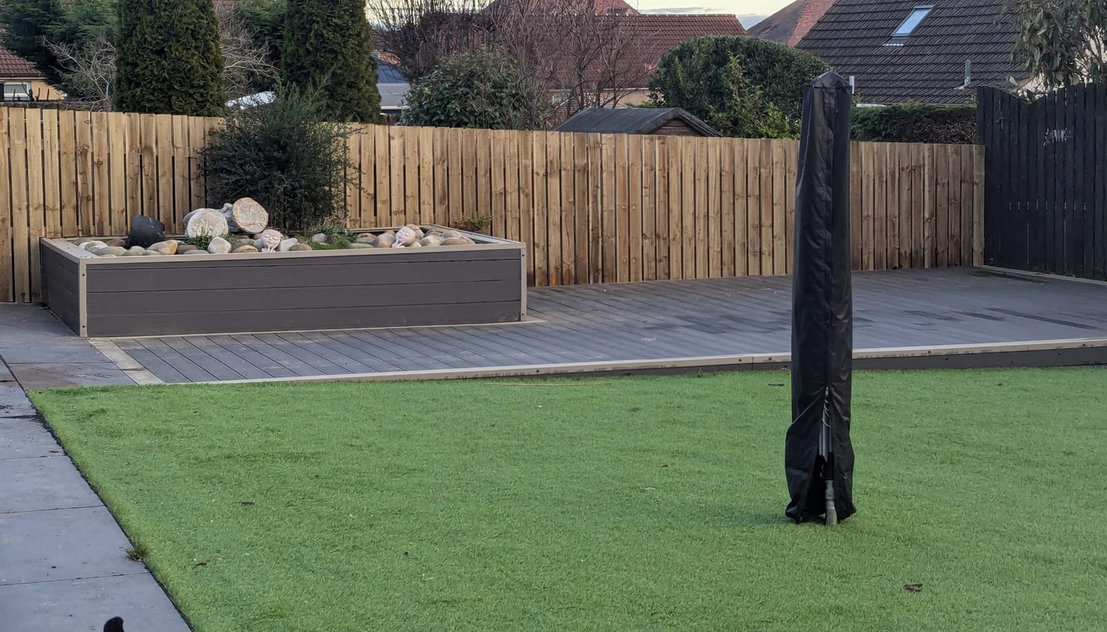 Artificial lawn, composite decking and a new fence in a back garden