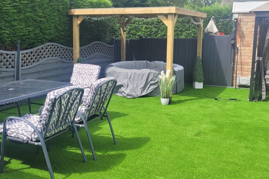 Artificial lawn with garden furniture and a pergola