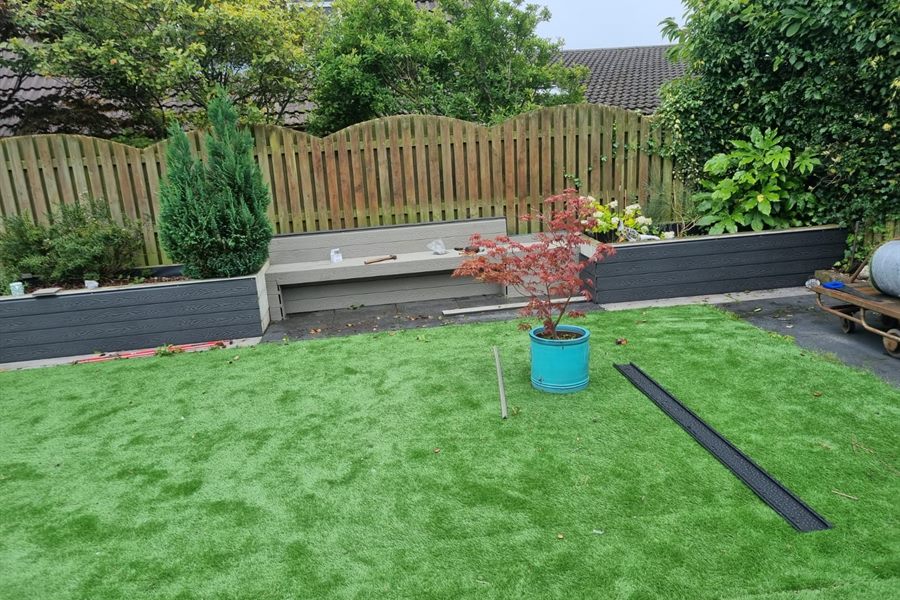 Artificial lawn with composite planters and a maple in a pot
