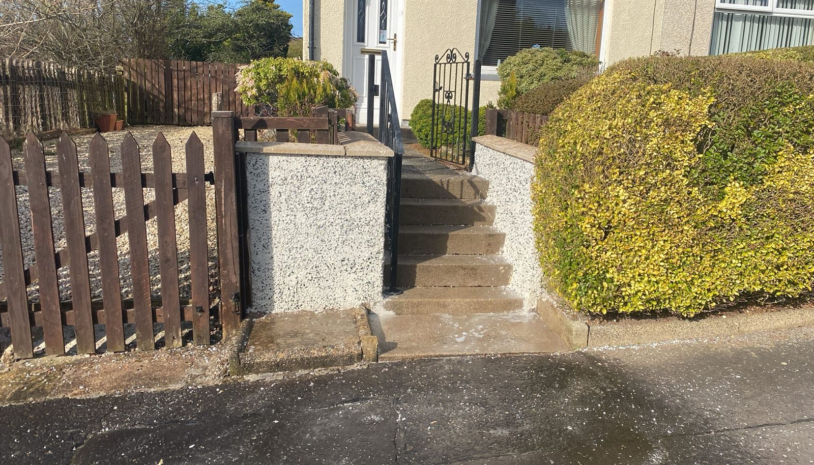 Freshly rendered front garden walls and steps with a new gate and railings