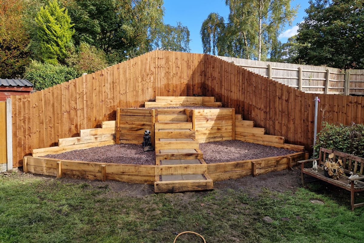 Three tiers of oak sleeper beds gravelled, with slabbed steps up the middle